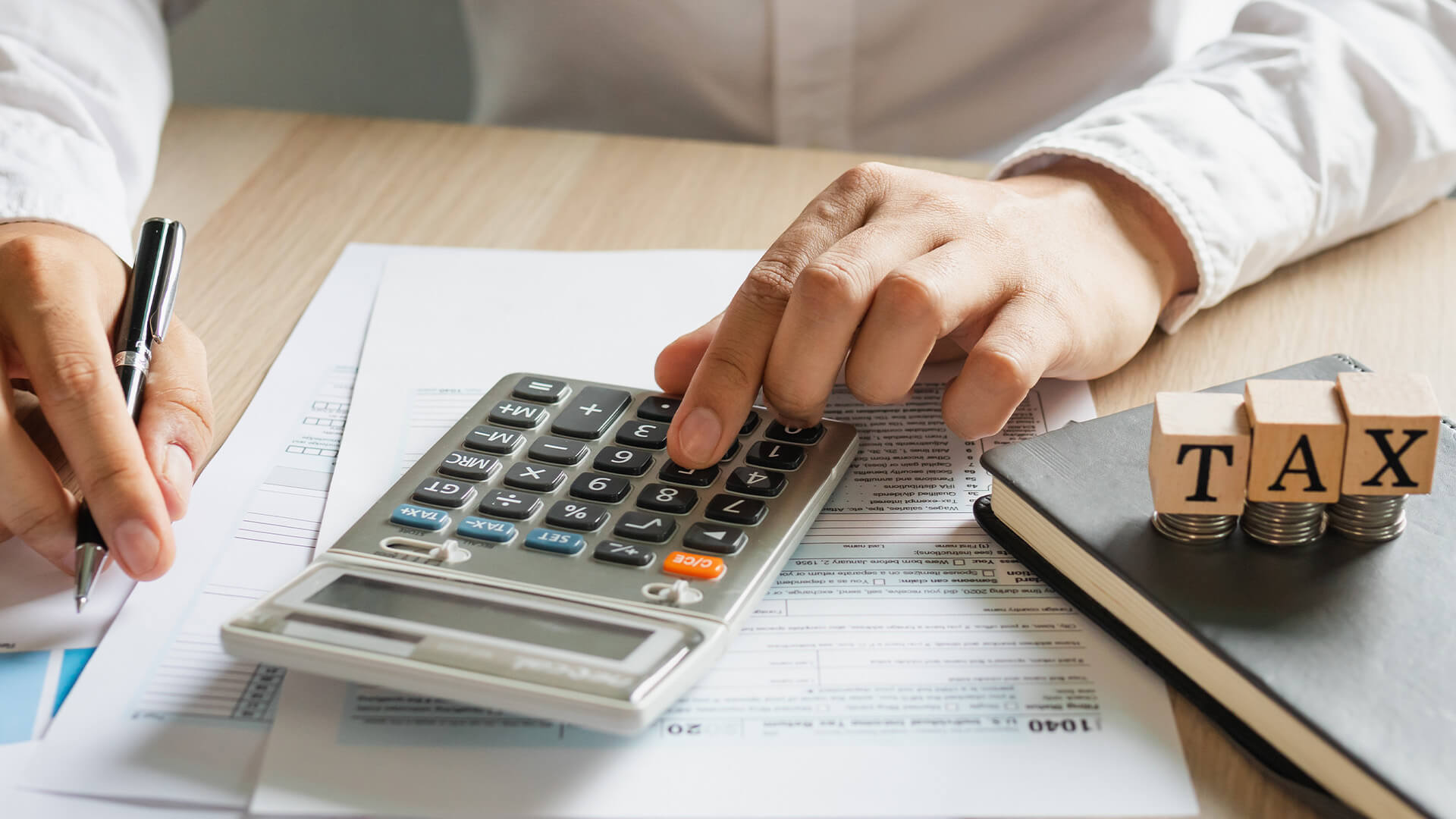 businessman,male is pressing a calculator to calculate tax income and expenses, bills, credit card for payment or payday at home